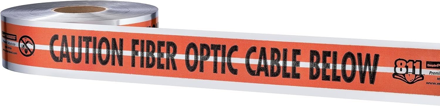 Roll of orange and white detectable tape with "Caution Fiber Optic Cable Below" warning text printed in black.
