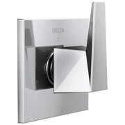 Chrome Delta diverter trim with square handle and black valve body mounted on white wall plate.