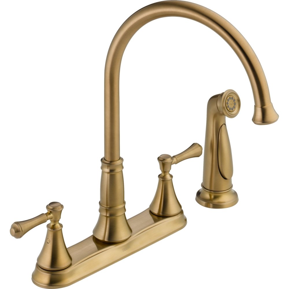 Brushed gold two-handle kitchen faucet with high curved spout and detachable spray head on right side.