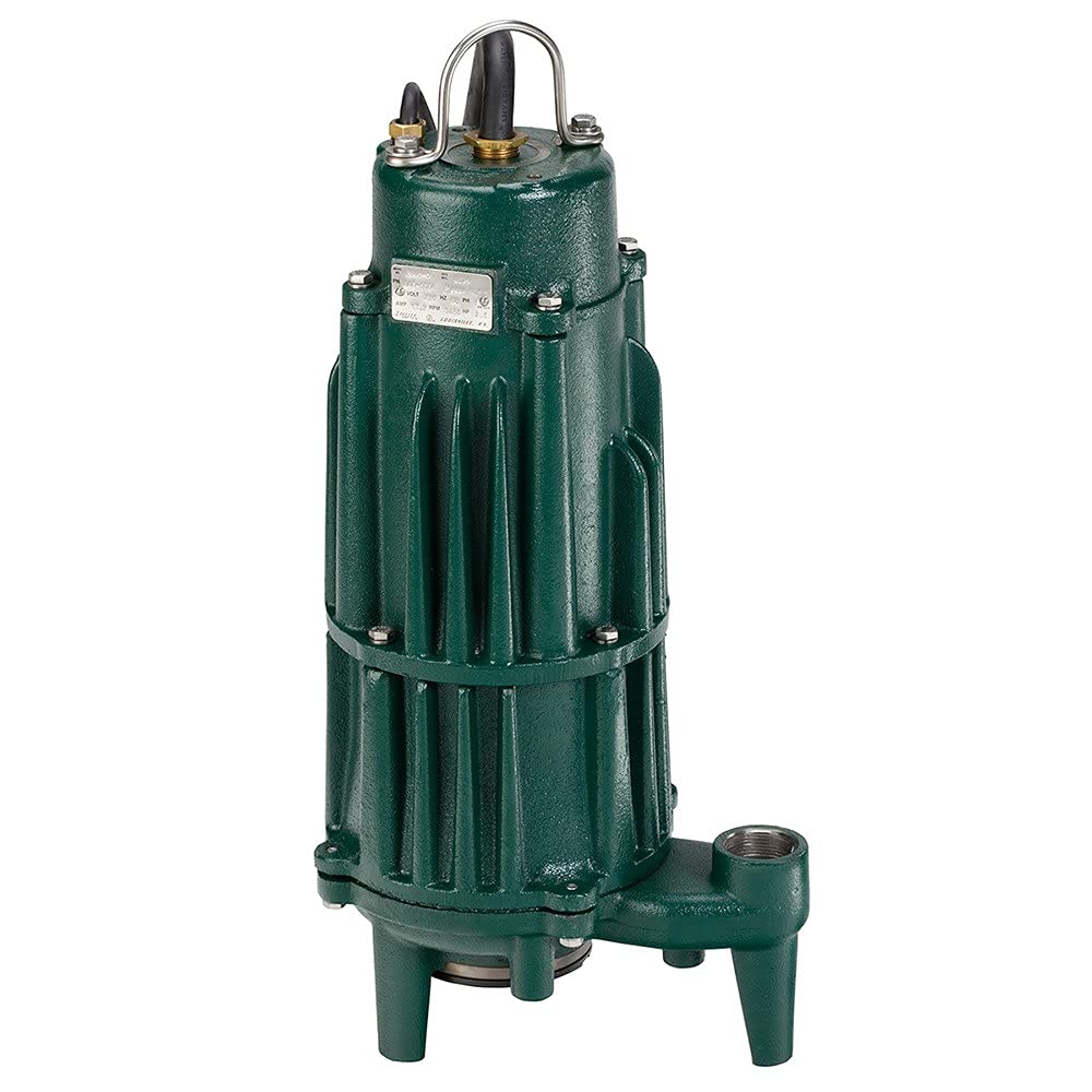 Green cast iron submersible sewage pump with metal handle, brass fittings, and four support legs.