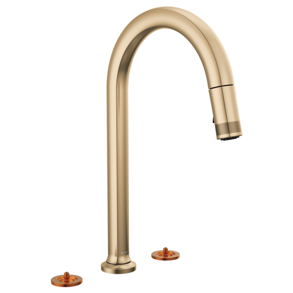 Gold widespread faucet with curved arc spout and pull-down spray head, shown with two copper-colored base inserts.