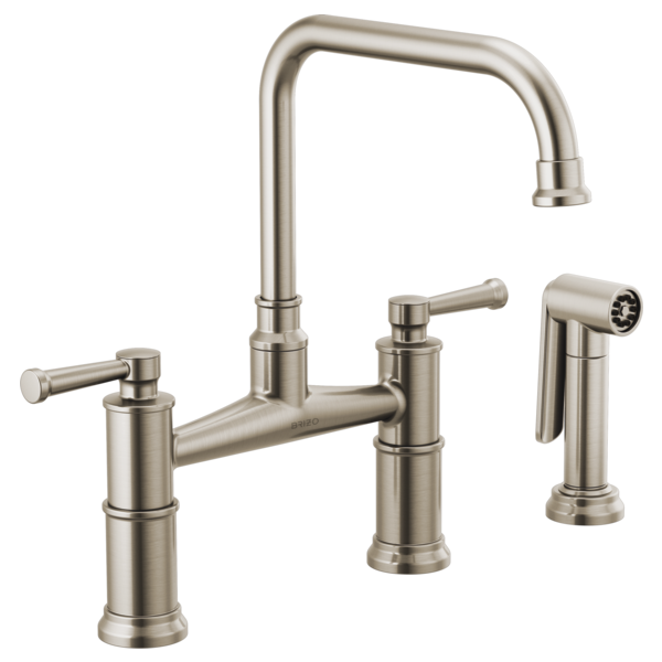 Brushed nickel bridge faucet with tall curved spout, dual lever handles, and matching side sprayer.