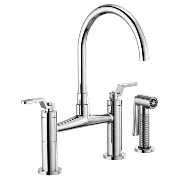 Chrome bridge faucet with curved arc spout, dual lever handles, and side spray attachment.