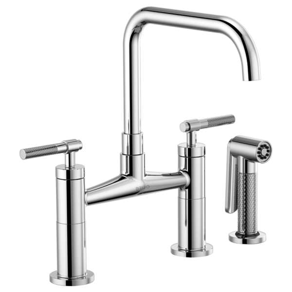 Chrome bridge faucet with tall square spout, dual knurled handles, and separate side sprayer attachment.