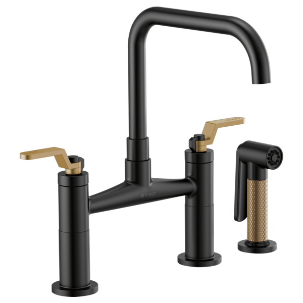 Black bridge faucet with square spout, two brass lever handles, and separate sprayer attachment.