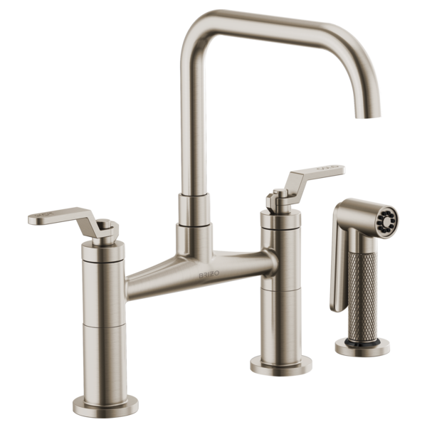 Stainless steel bridge faucet with tall square spout, two lever handles, and matching side spray attachment.
