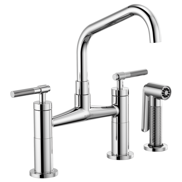 Chrome bridge faucet with angled spout, two knurled handles, and side spray sprayer.