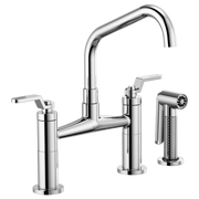 Chrome bridge faucet with angled spout, two lever handles, and separate sprayer attachment.
