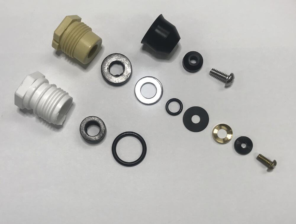 Mansfield wall hydrant kit components including brass and plastic threaded fittings, rubber seals, washers, and metal screws 