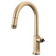 Brizo Kintsu pull-down kitchen faucet with arc spout in brushed gold finish, shown with spray head retracted.