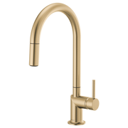 Luxe gold pull-down kitchen faucet with arc spout and single handle lever on right side.