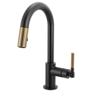Matte black kitchen faucet with arc spout, knurled gold handle, and pull-down spray head.