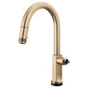 Gold pull-down kitchen faucet with curved spout and touchless sensor control on base.