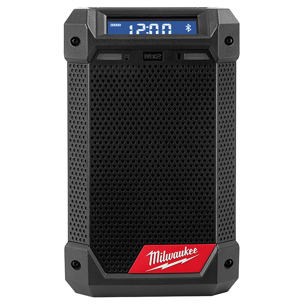 Black and gray Milwaukee M12 cordless radio with blue digital display showing 12:00, speaker grille, and red Milwaukee logo b