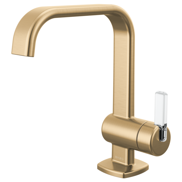 Brushed gold single-handle bathroom faucet with curved spout and white lever handle on square base.