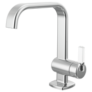 Chrome single-handle lavatory faucet with curved spout and cylindrical handle on square base.