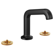 Matte black widespread lavatory faucet with angled spout and two brass-colored circular mounting plates.