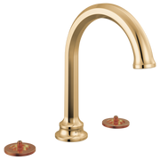 Polished gold widespread bathroom faucet with arcing spout and two circular copper-colored handle bases.