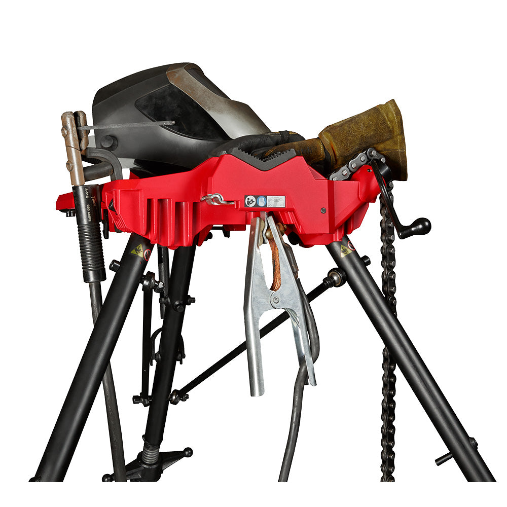 Red and black portable chain vise mounted on tripod stand with adjustment lever and chain mechanism visible.