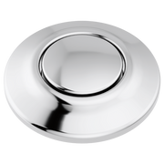 Chrome-finished circular air switch with dual outlet and recessed button center.