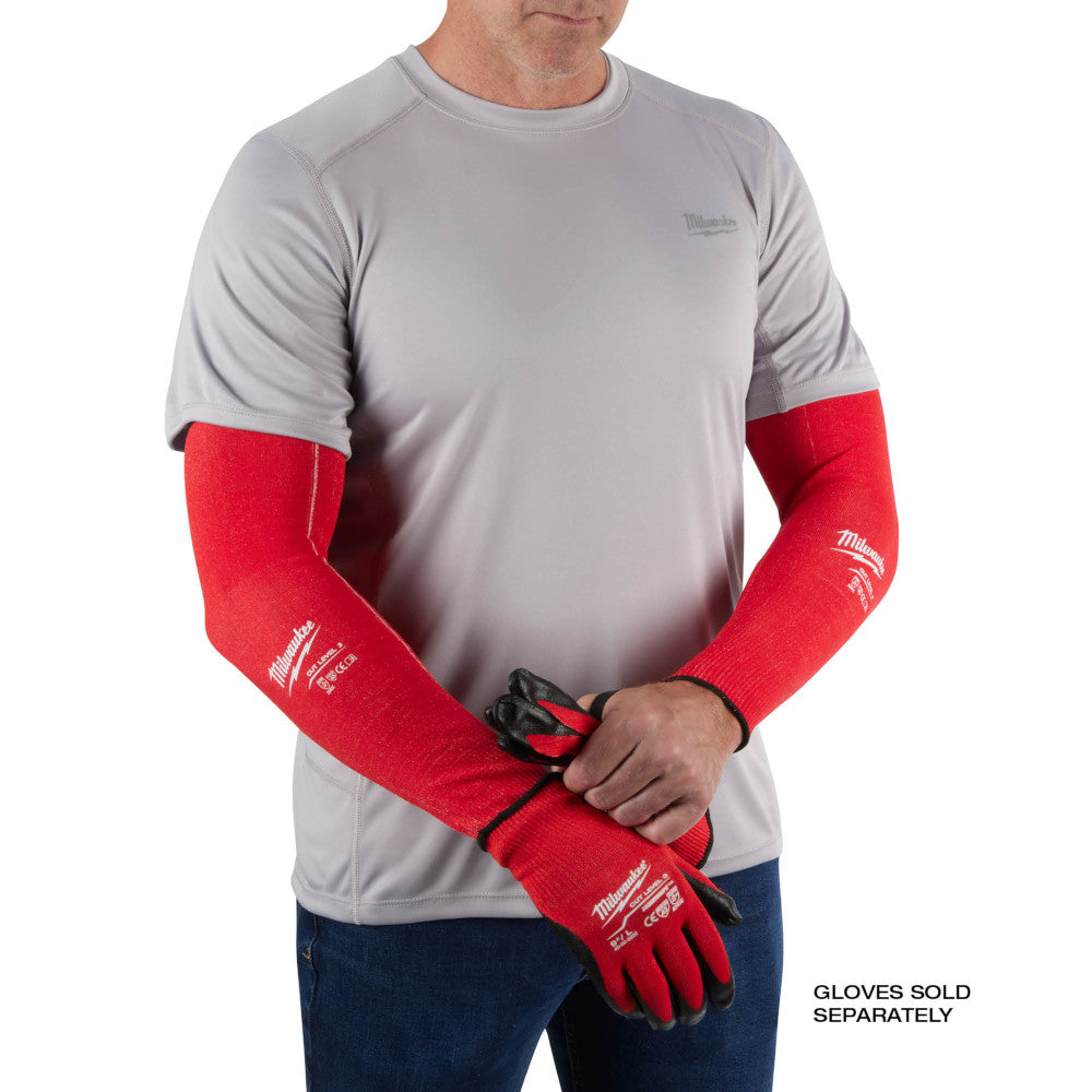 Red protective sleeves covering both forearms, worn over gray shirt, with Milwaukee branding visible.