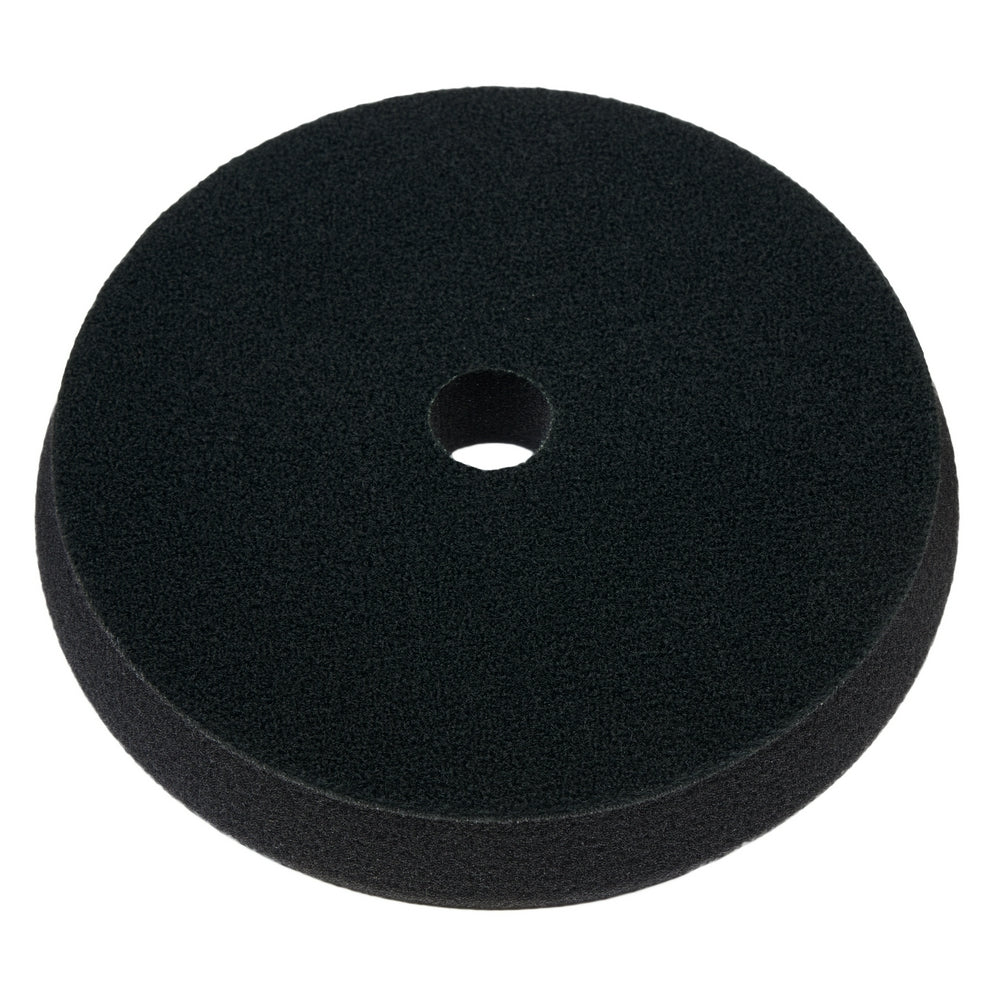 Black foam cutting pad, 6 inches diameter, with center hole for tool attachment.