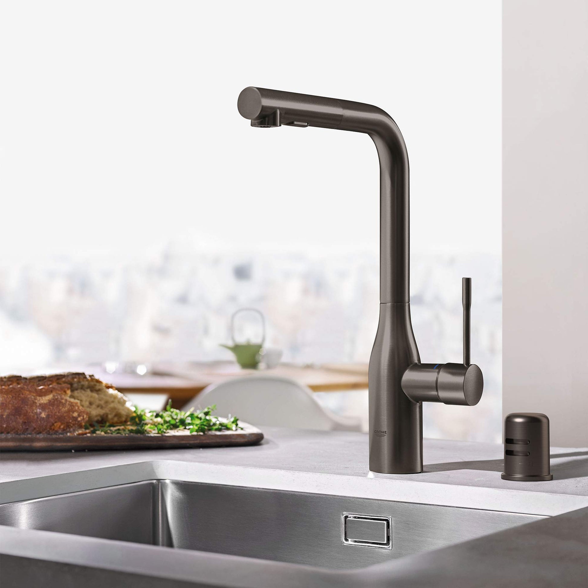 Hard graphite air gap component with cylindrical body and rounded top for kitchen sink installation.