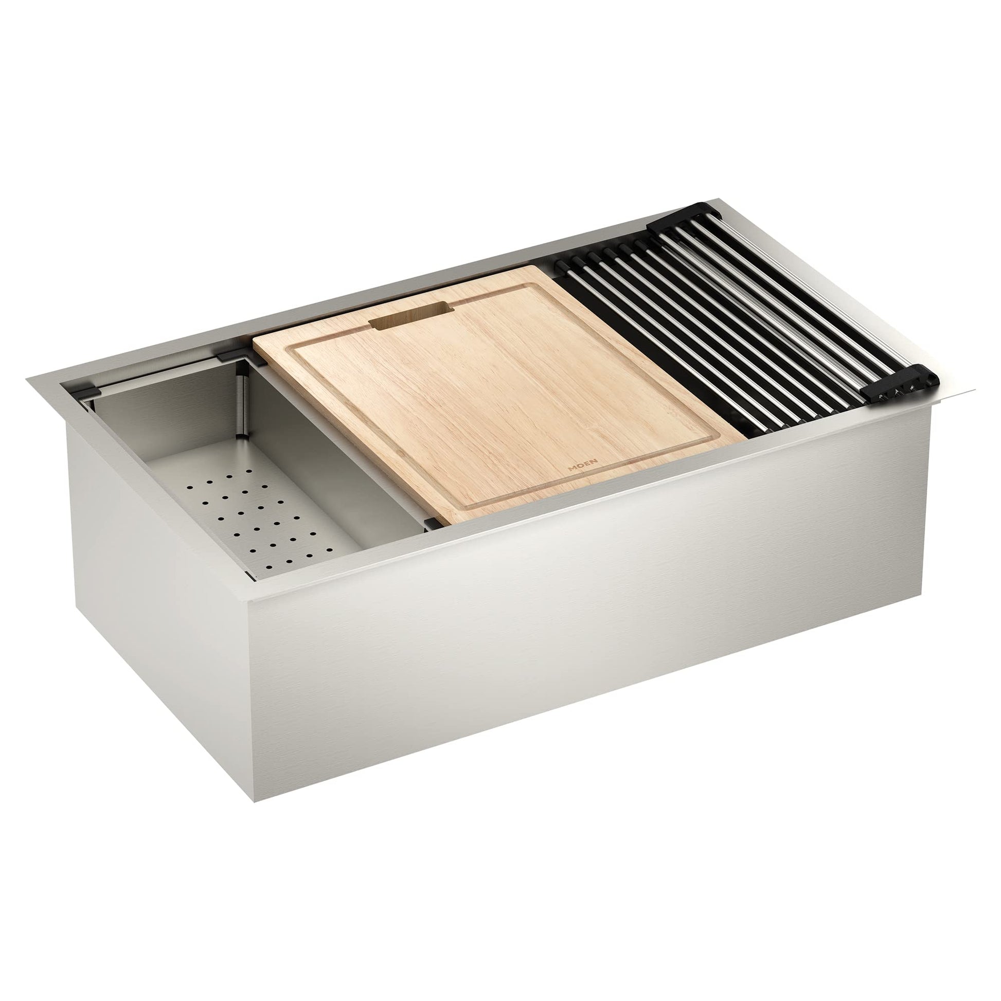 Stainless steel undermount sink with wooden cutting board, black drying rack, colander, and grid accessories displayed.