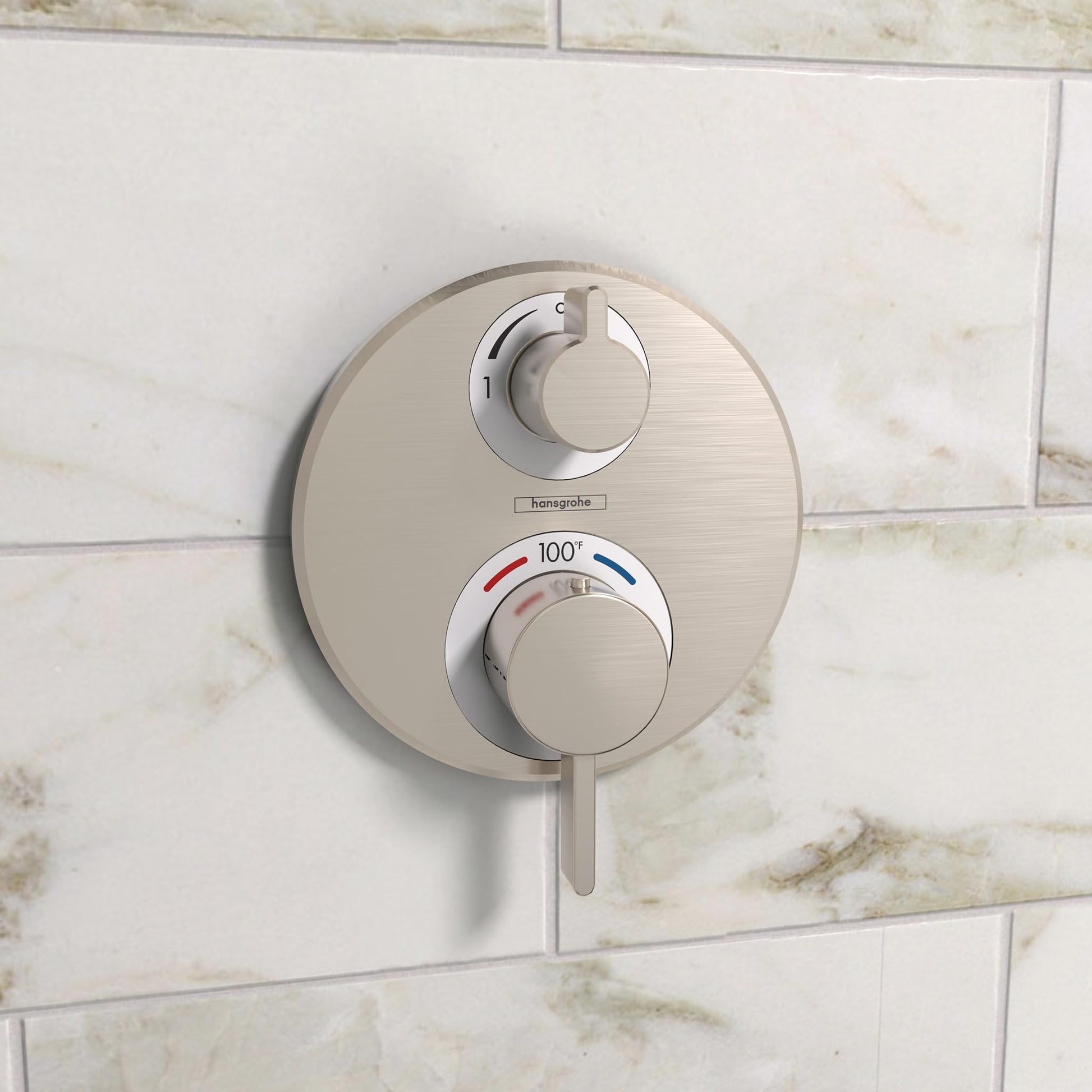 Brushed nickel round thermostatic shower valve with two control knobs and temperature dial mounted on tile wall.