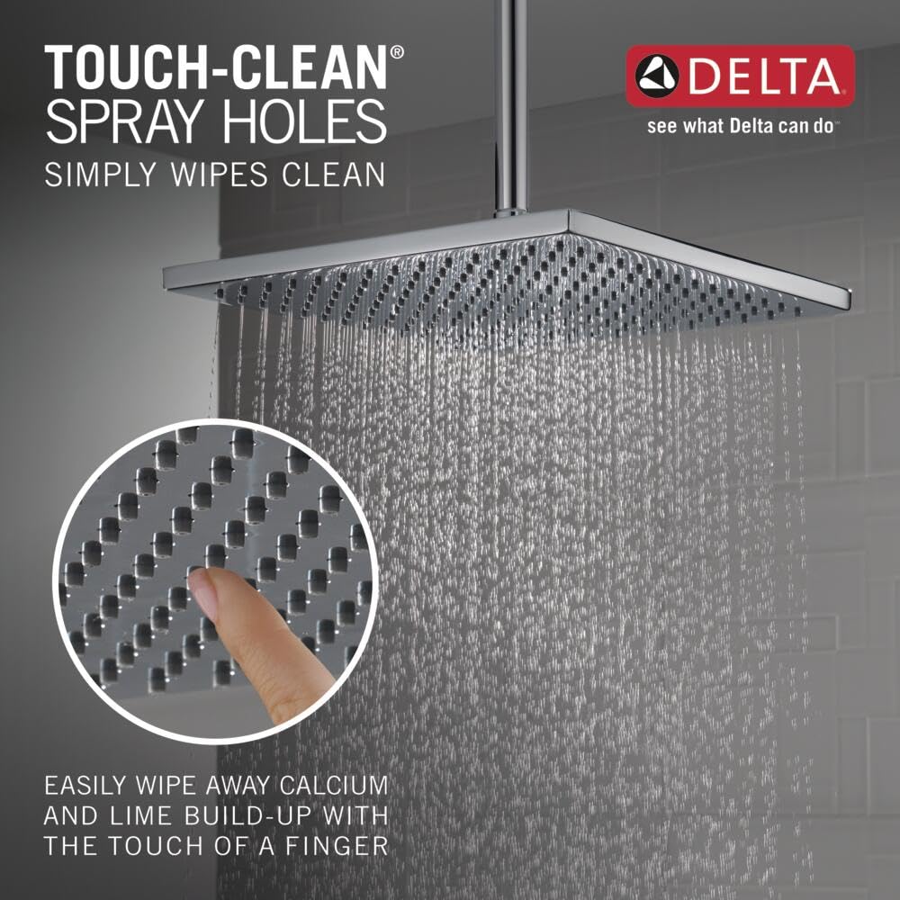 Chrome square raincan shower head with multiple spray holes mounted from ceiling pipe, water streaming downward.