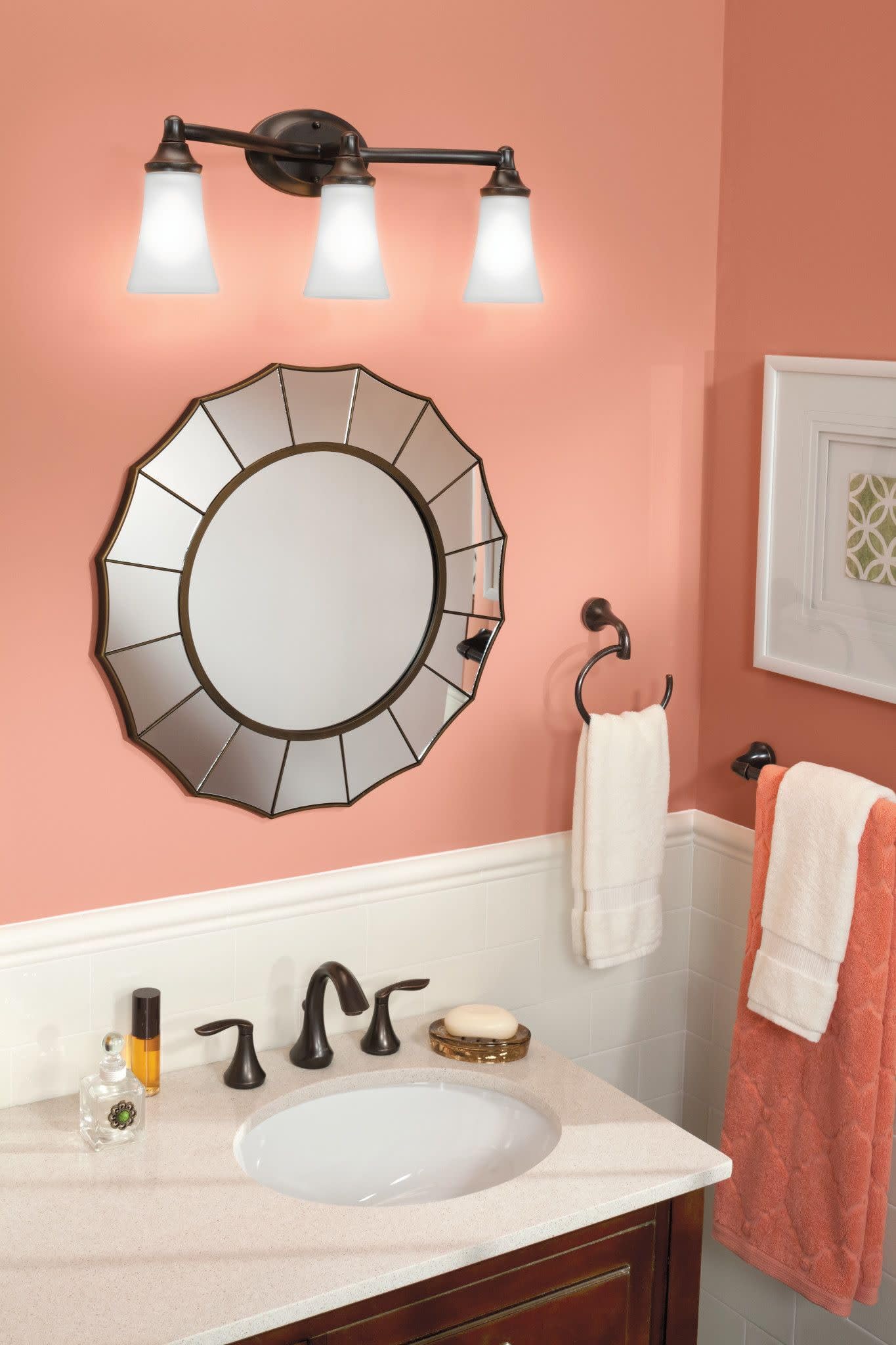 Oil rubbed bronze two-handle high arc faucet with widespread placement on white bathroom sink counter.