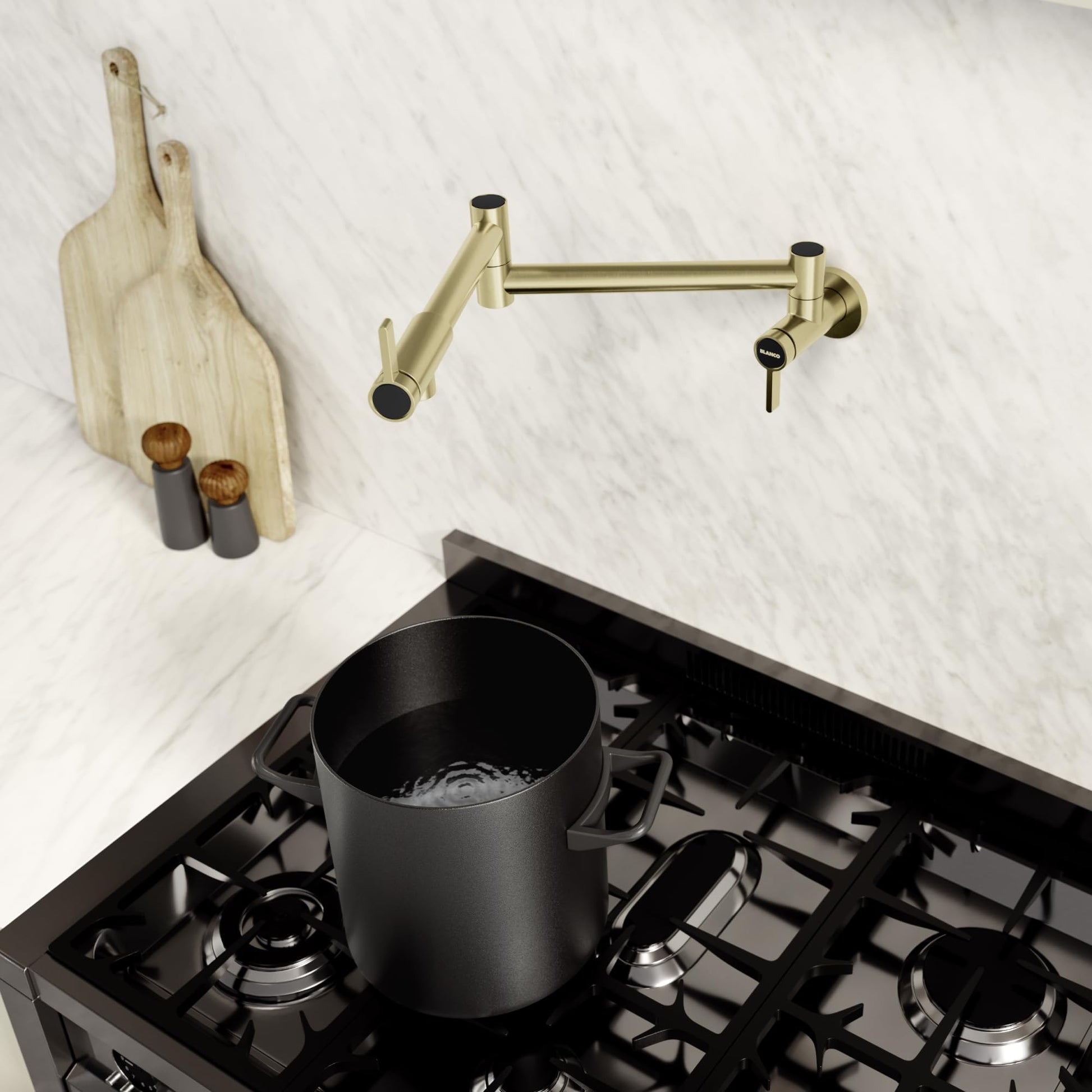 Satin gold wall-mounted potfiller faucet with articulating arm over gas cooktop holding black pot.