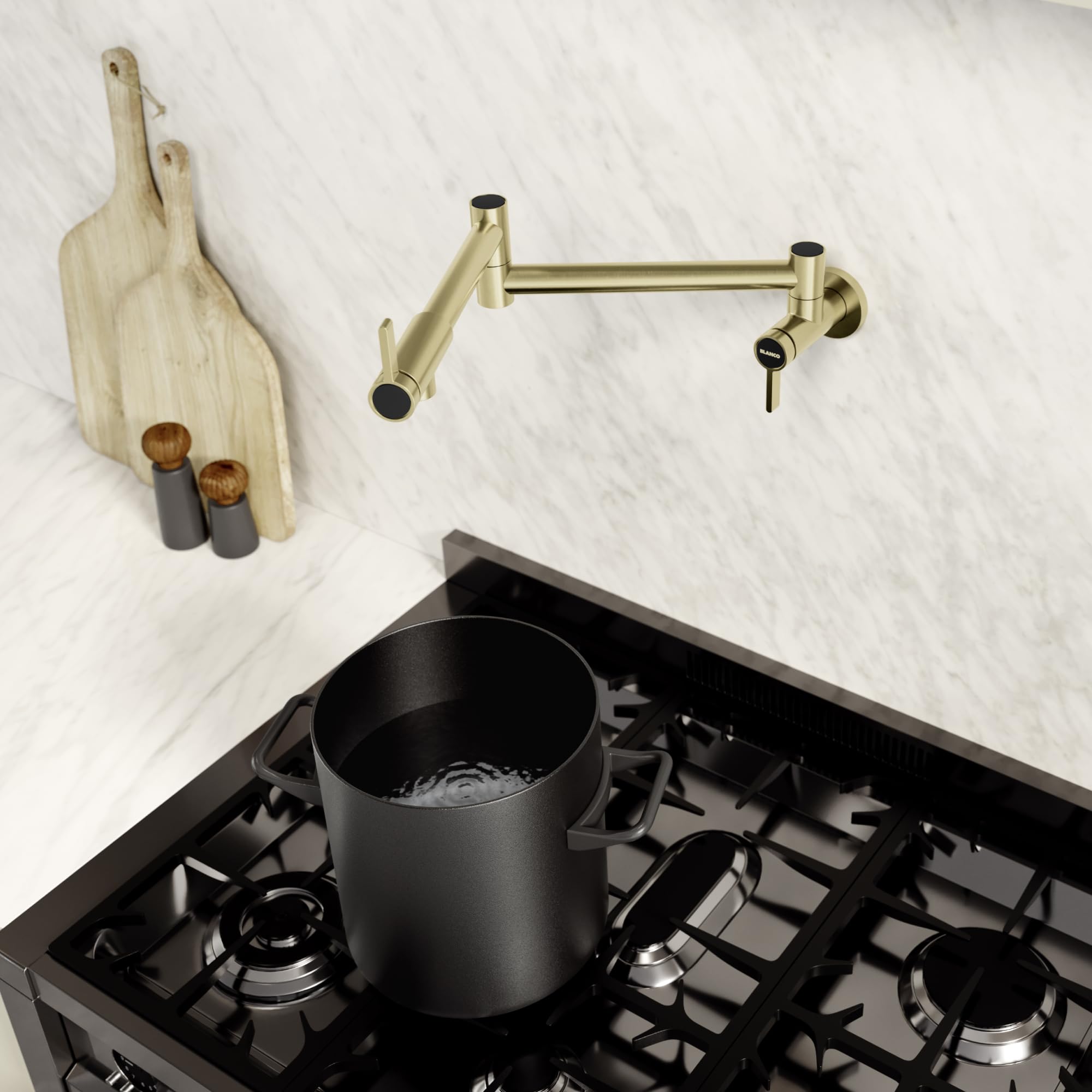 Satin gold wall-mounted potfiller faucet with articulating arm over gas cooktop holding black pot.
