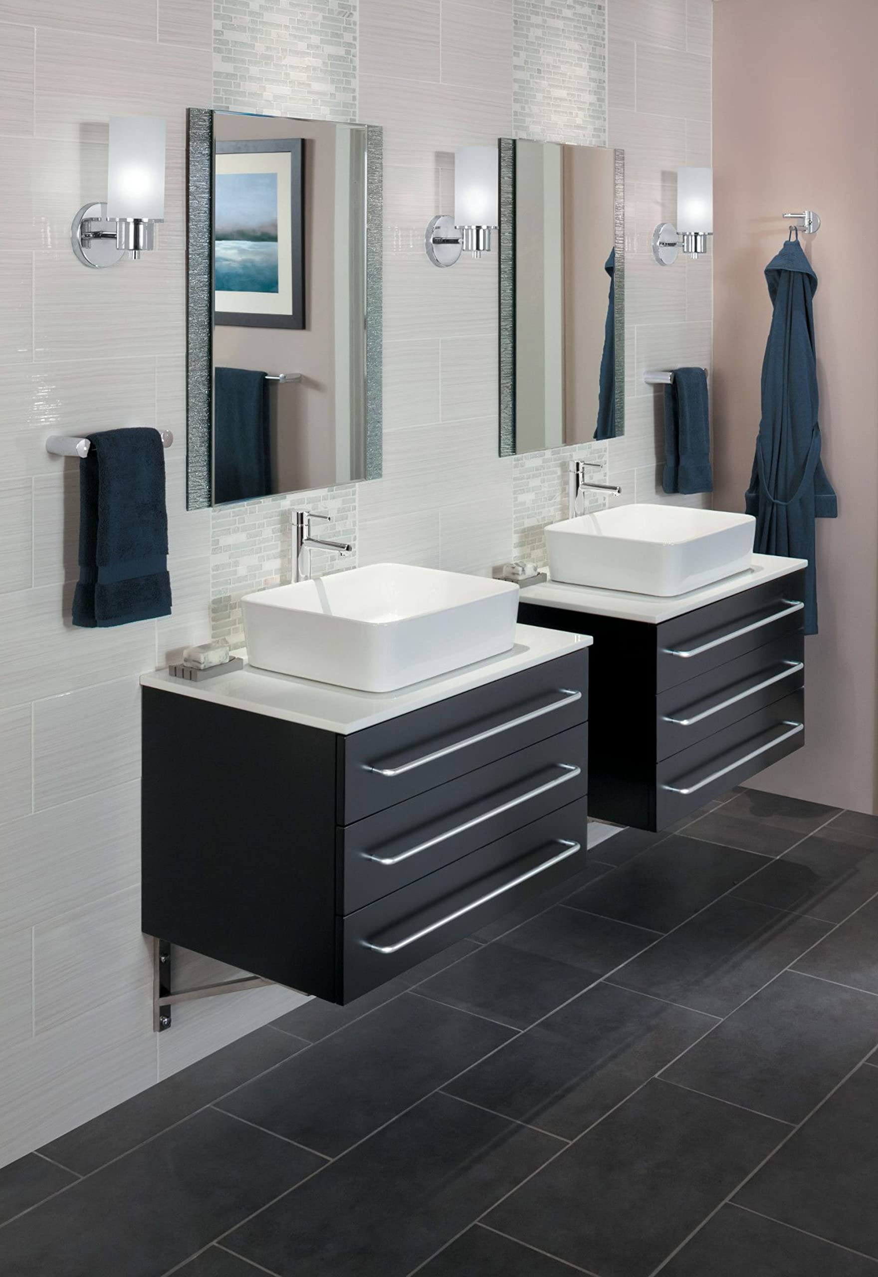 Chrome double swivel robe hook mounted on bathroom wall beside mirror above vanity.