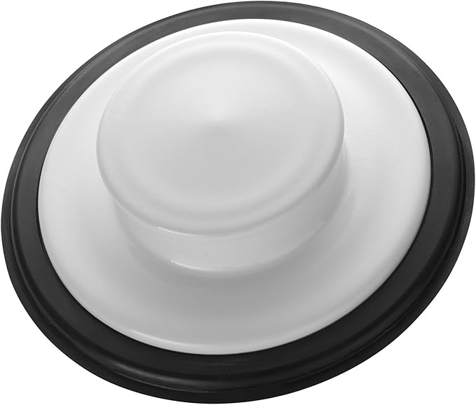 White and black sink stopper with raised center dome and rubber ring base.
