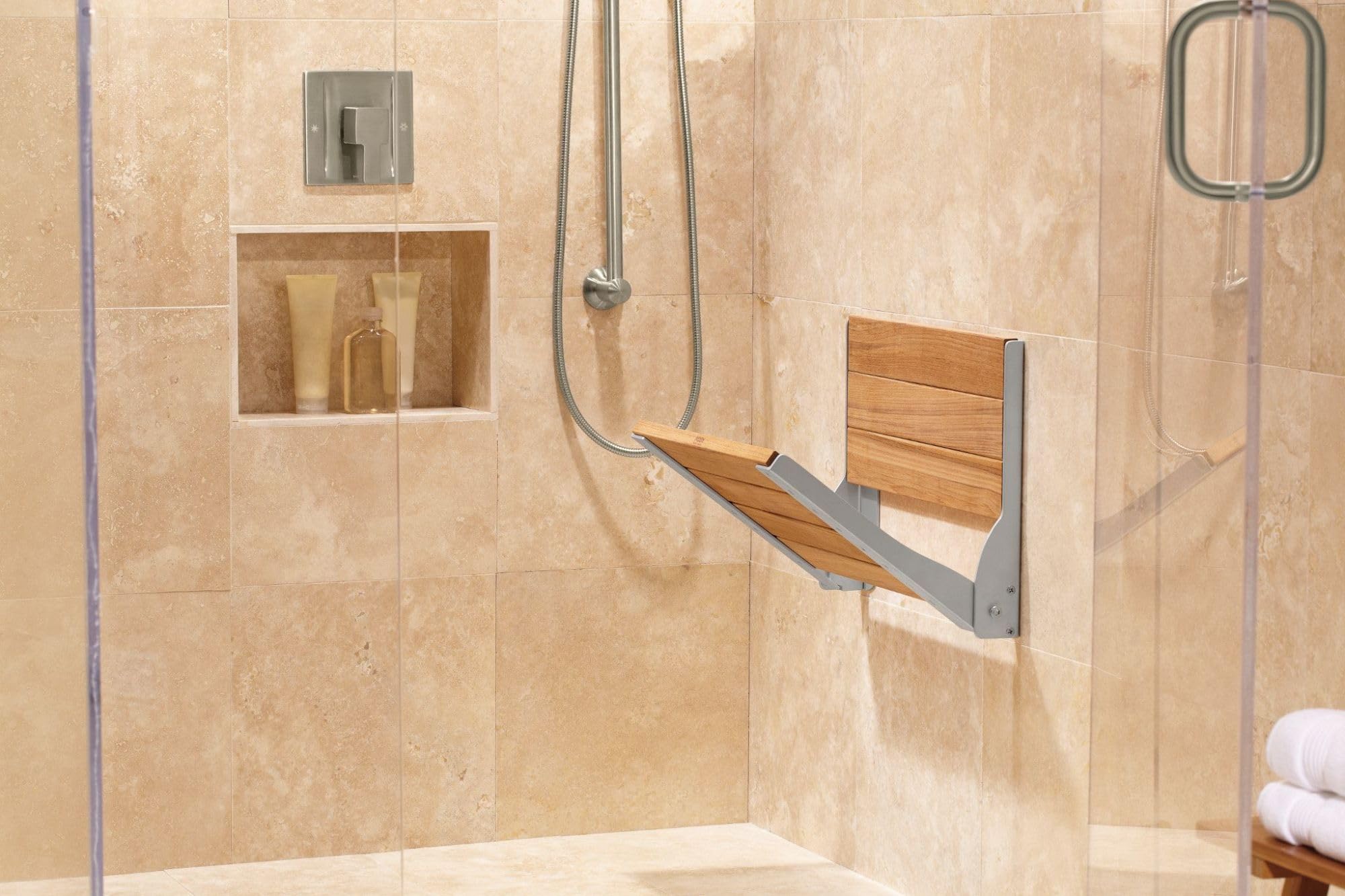 Brushed nickel single-handle shower valve trim with angular design mounted on beige tile shower wall.
