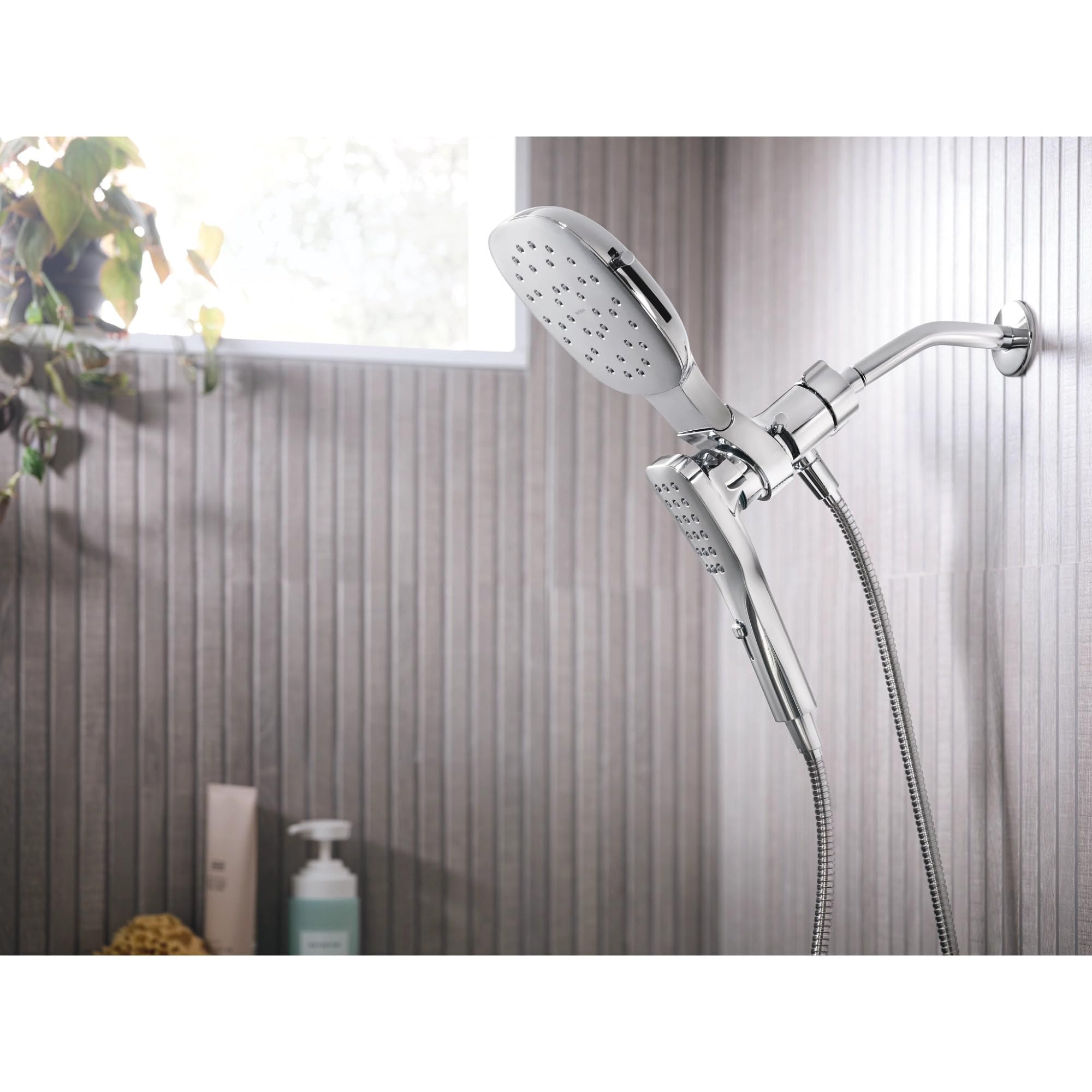Chrome shower system with square rain head and detachable hand shower connected by flexible hose.