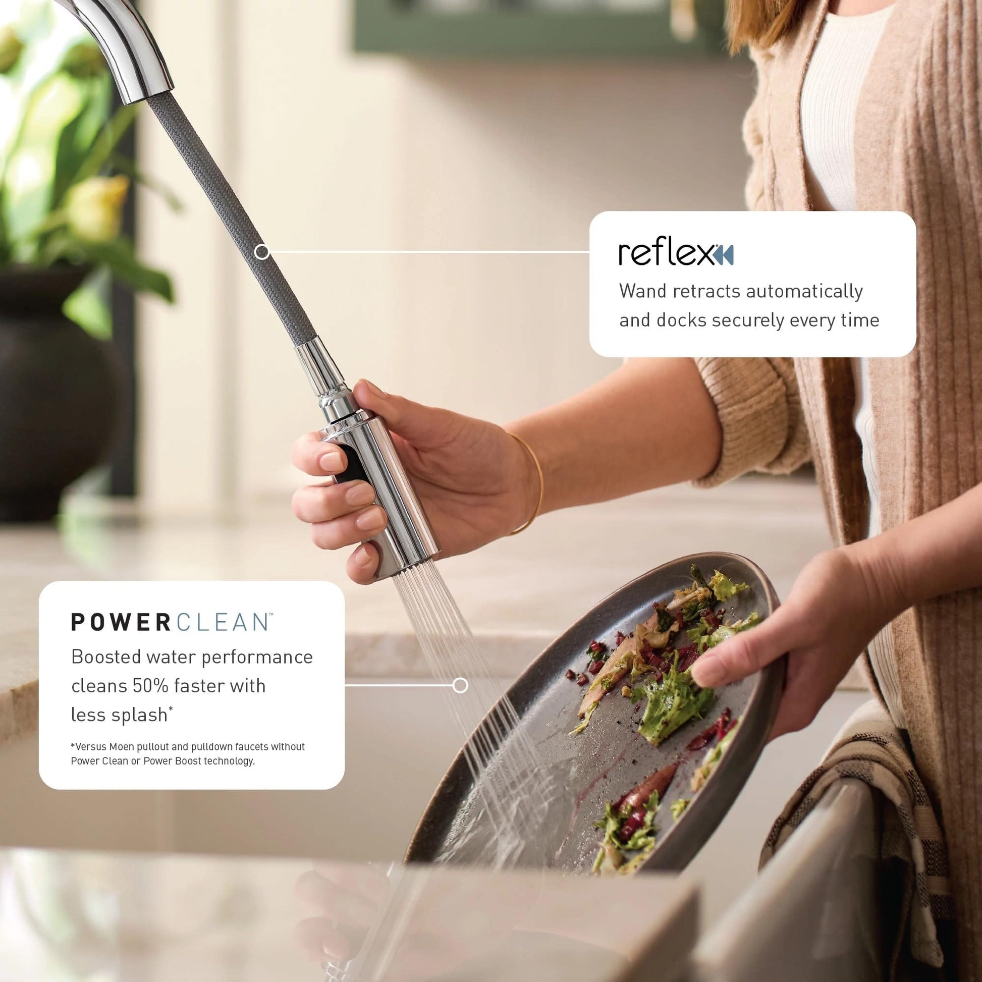 Chrome pulldown kitchen faucet with flexible hose and spray head held over a bowl of food.
