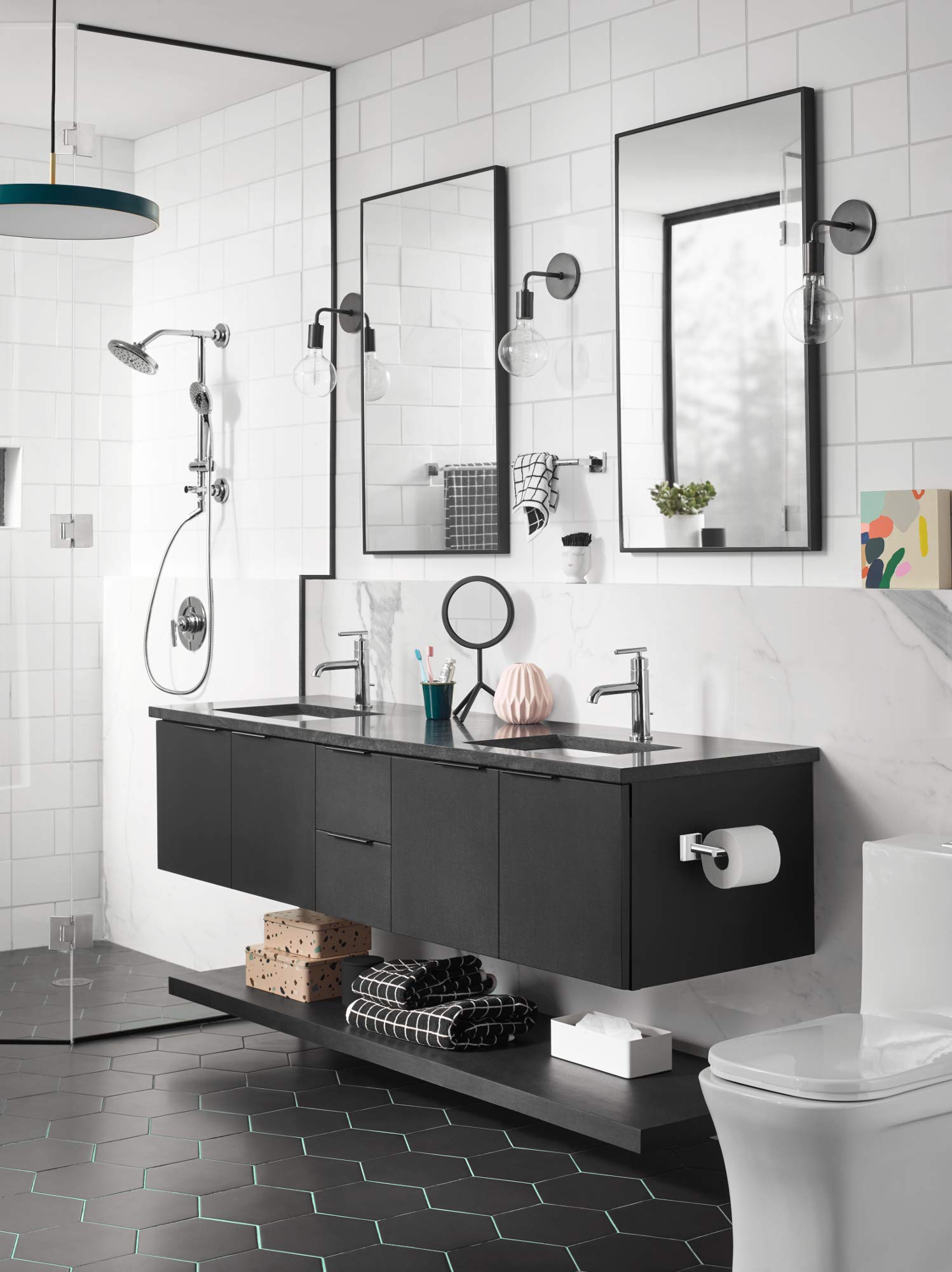 Chrome towel bar mounted horizontally on white subway tile bathroom wall above black vanity.