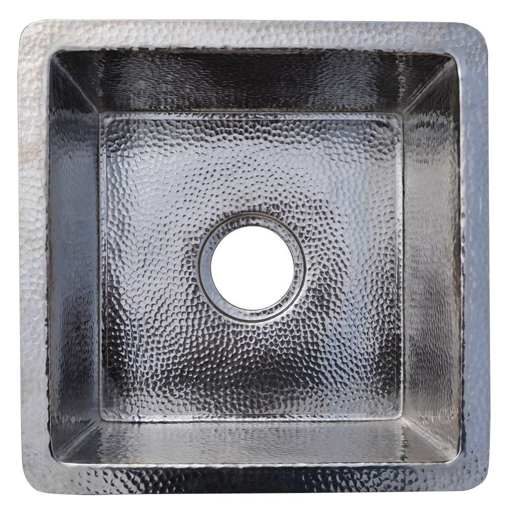 Polished nickel square sink with hammered texture interior and drain opening, viewed from above.