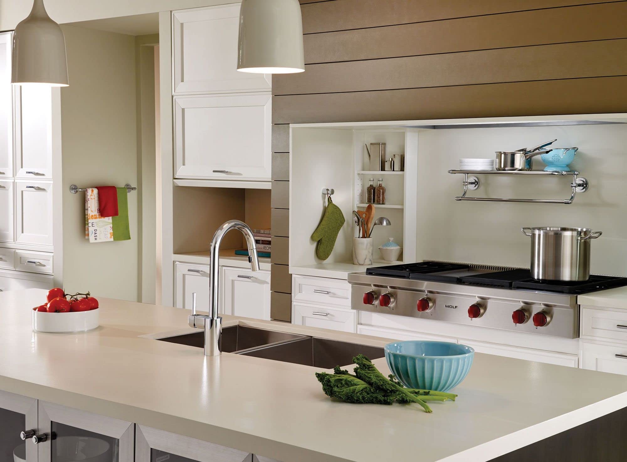 Chrome robe hook with modern minimalist design mounted on kitchen wall.