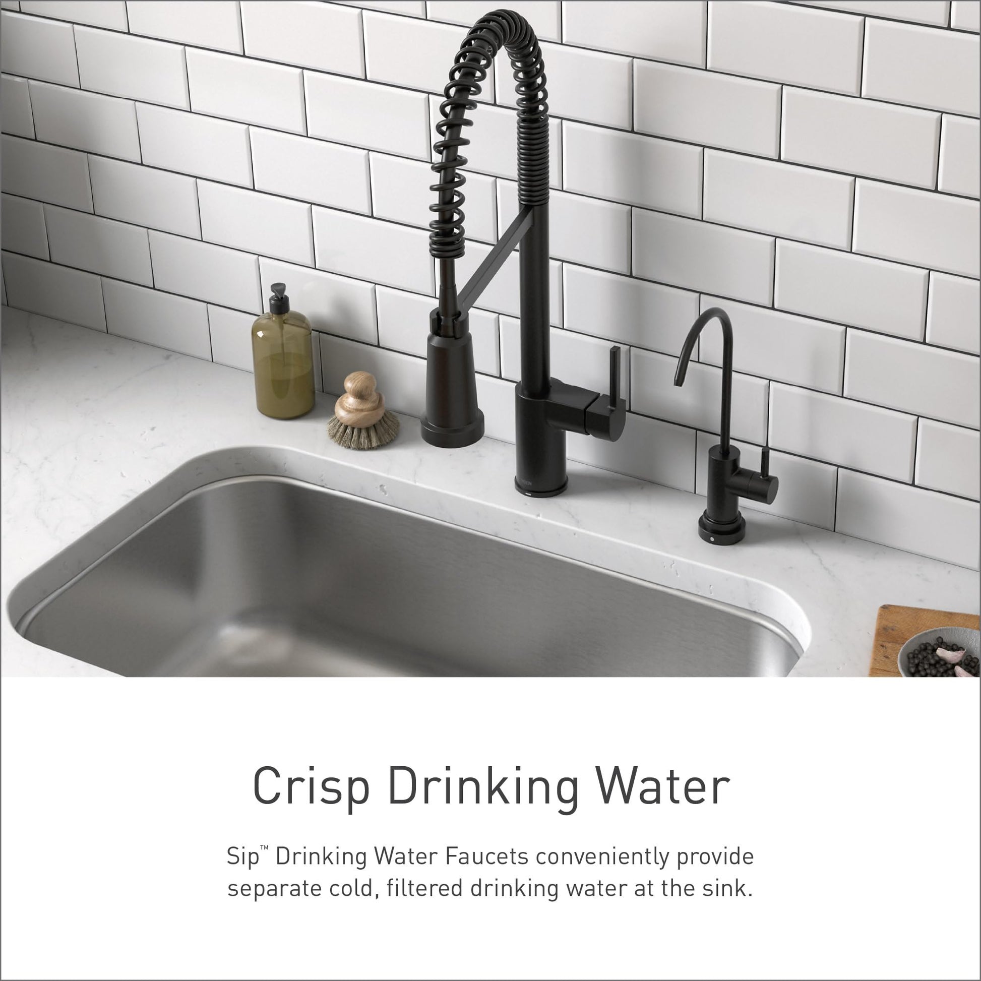 Matte black drinking water faucet with coiled spring spout installed at kitchen sink next to main faucet.