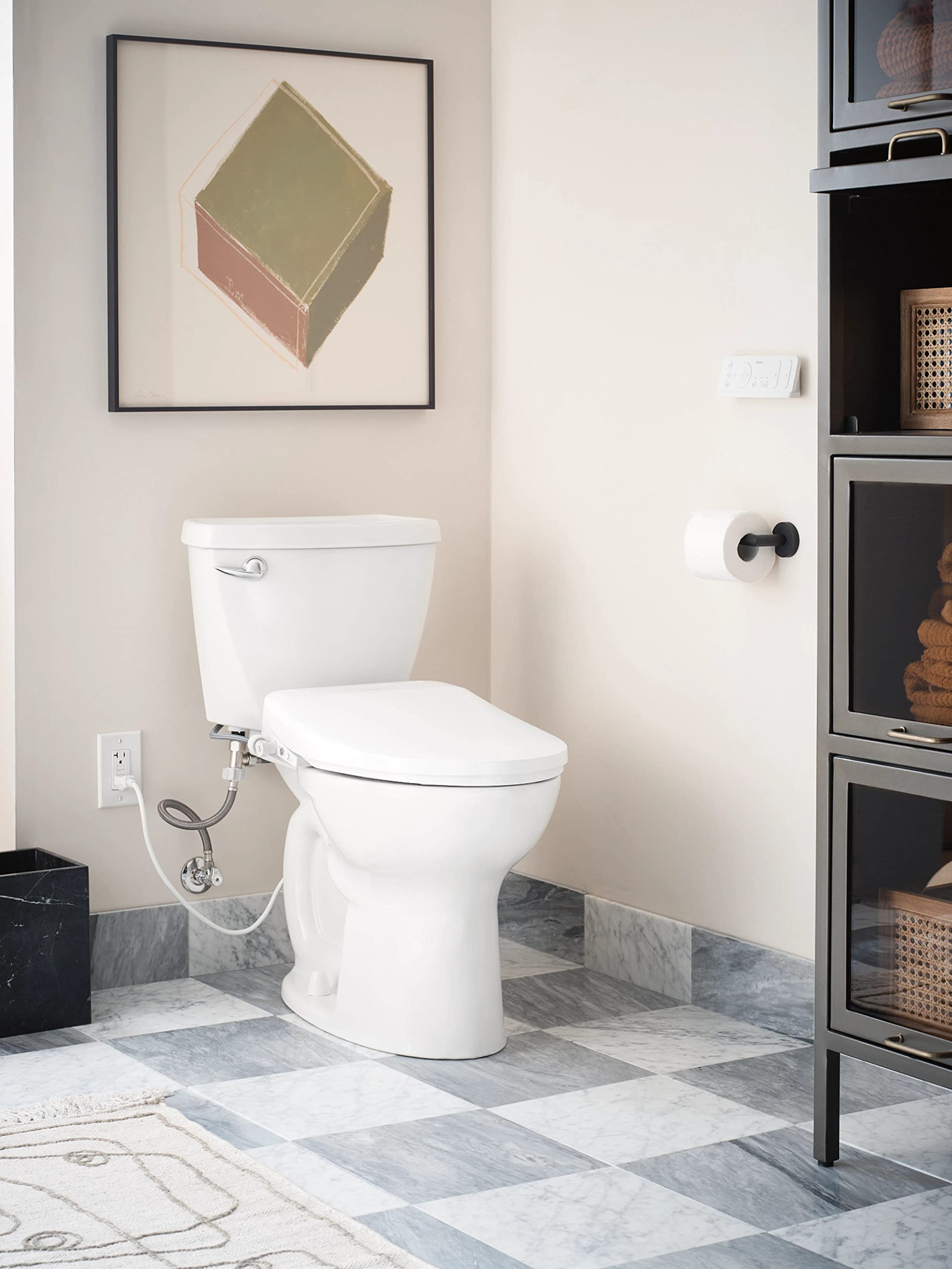 White electronic bidet toilet seat with heated seat, attached to white porcelain bowl in bathroom setting.