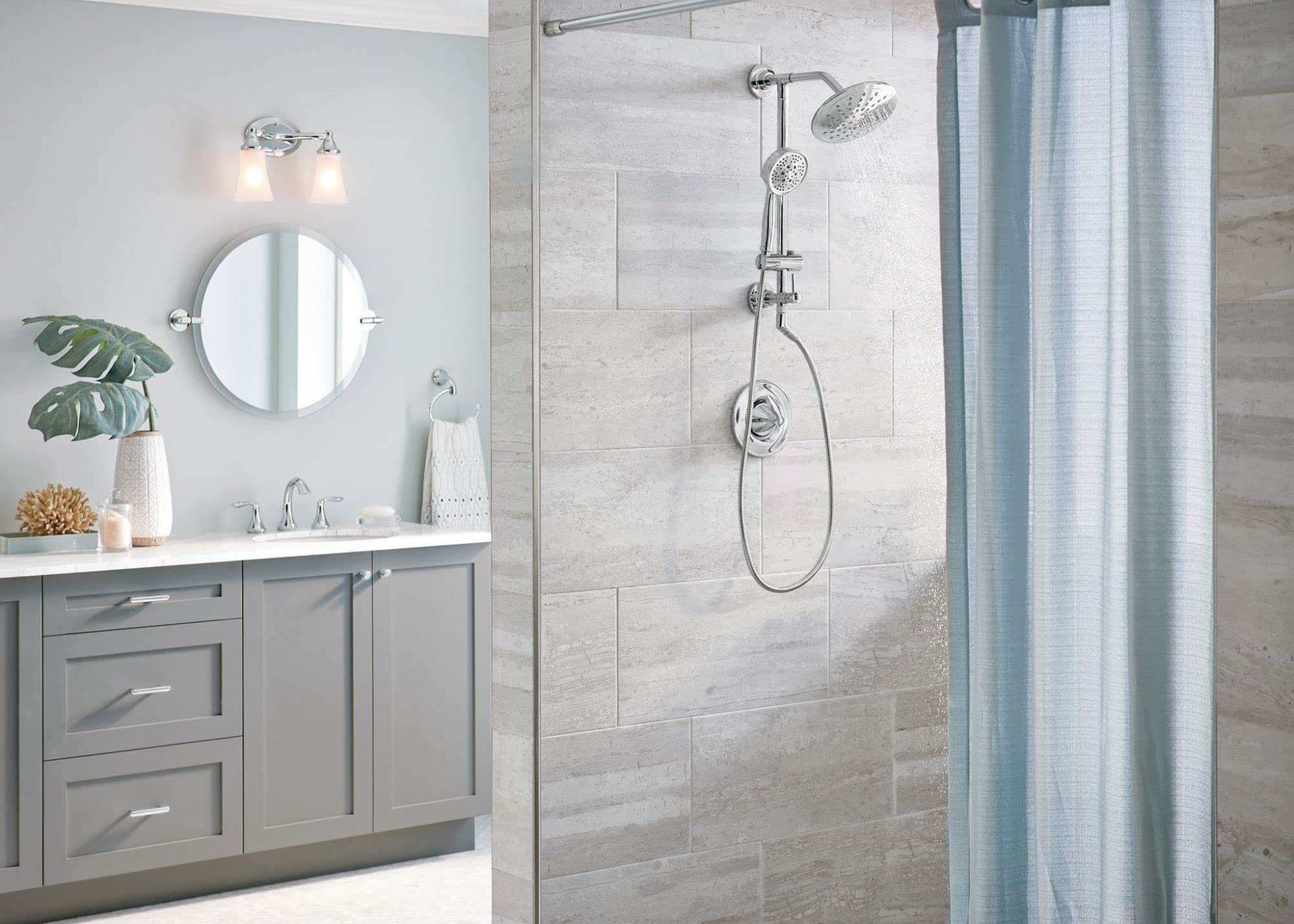 Chrome shower system with rainshower head, handheld wand, and control handle mounted on tile wall.