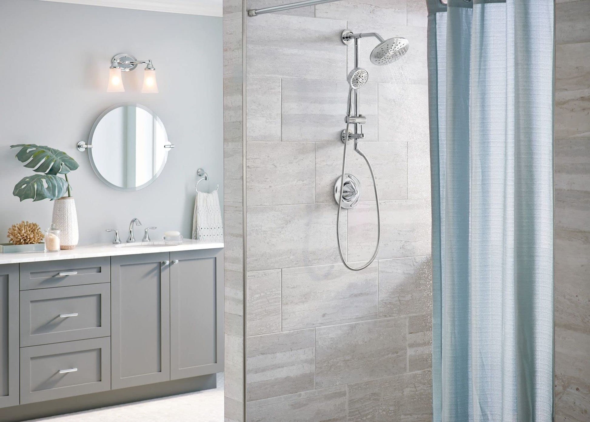 Chrome shower system with adjustable slidebar, handheld showerhead, and fixed overhead showerhead mounted on tile wall.