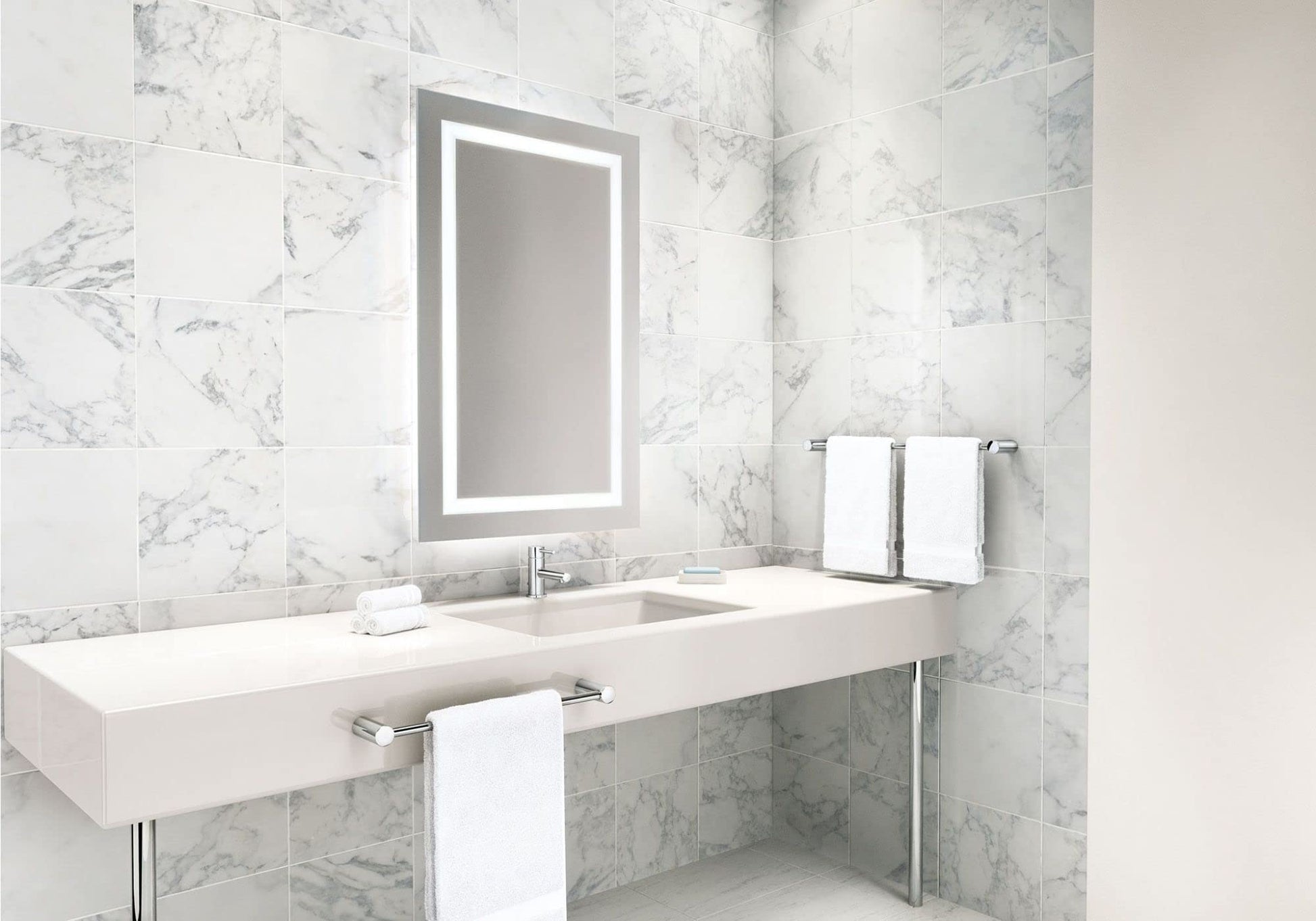 Chrome towel bar mounted horizontally on marble tile bathroom wall above white sink counter.