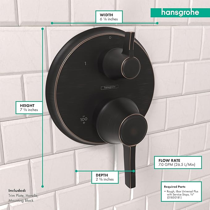Round rubbed bronze thermostatic trim with two handles and diverter mounted on white subway tile wall.