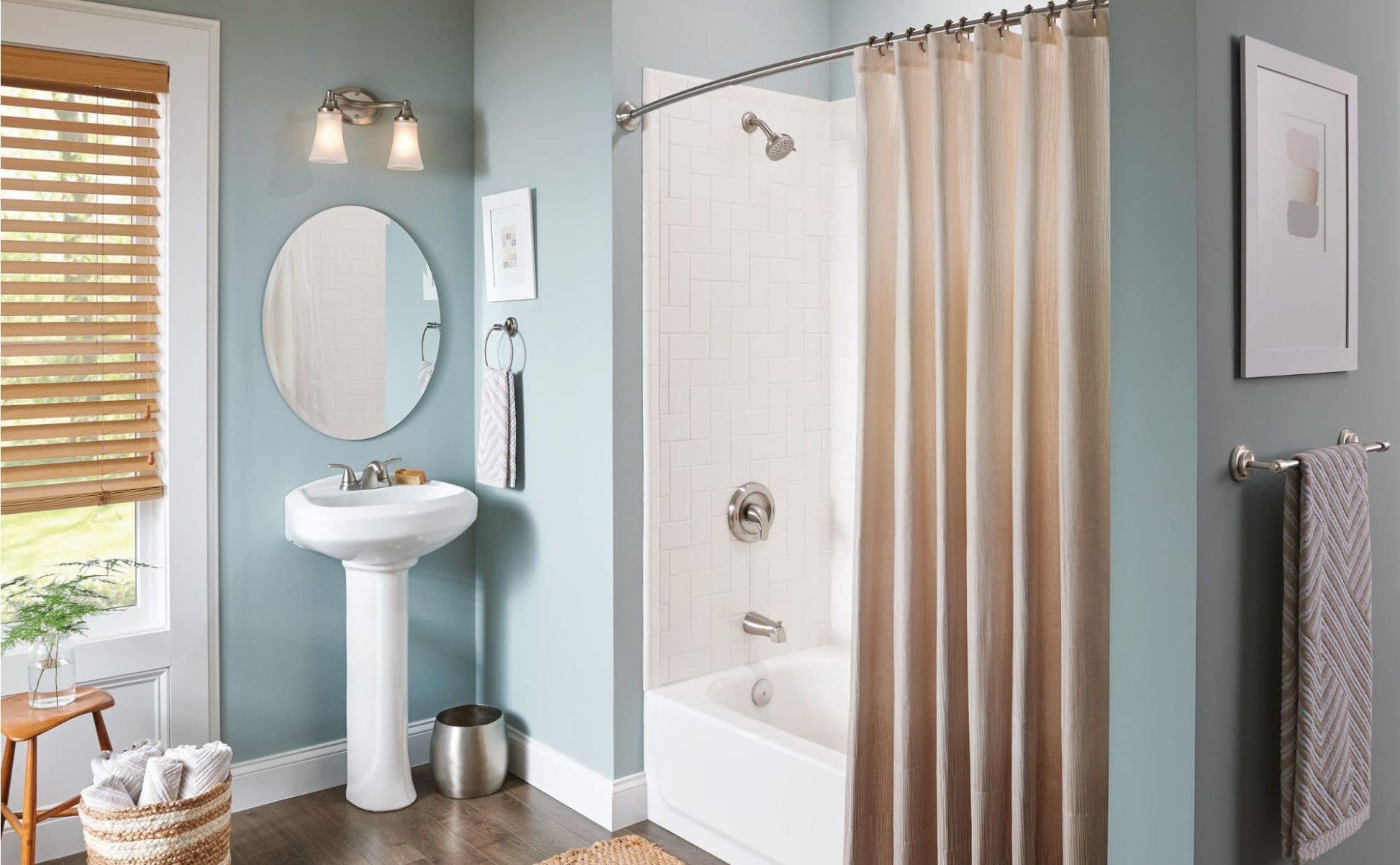 Brushed nickel wall-mount towel ring installed on bathroom wall next to shower enclosure.