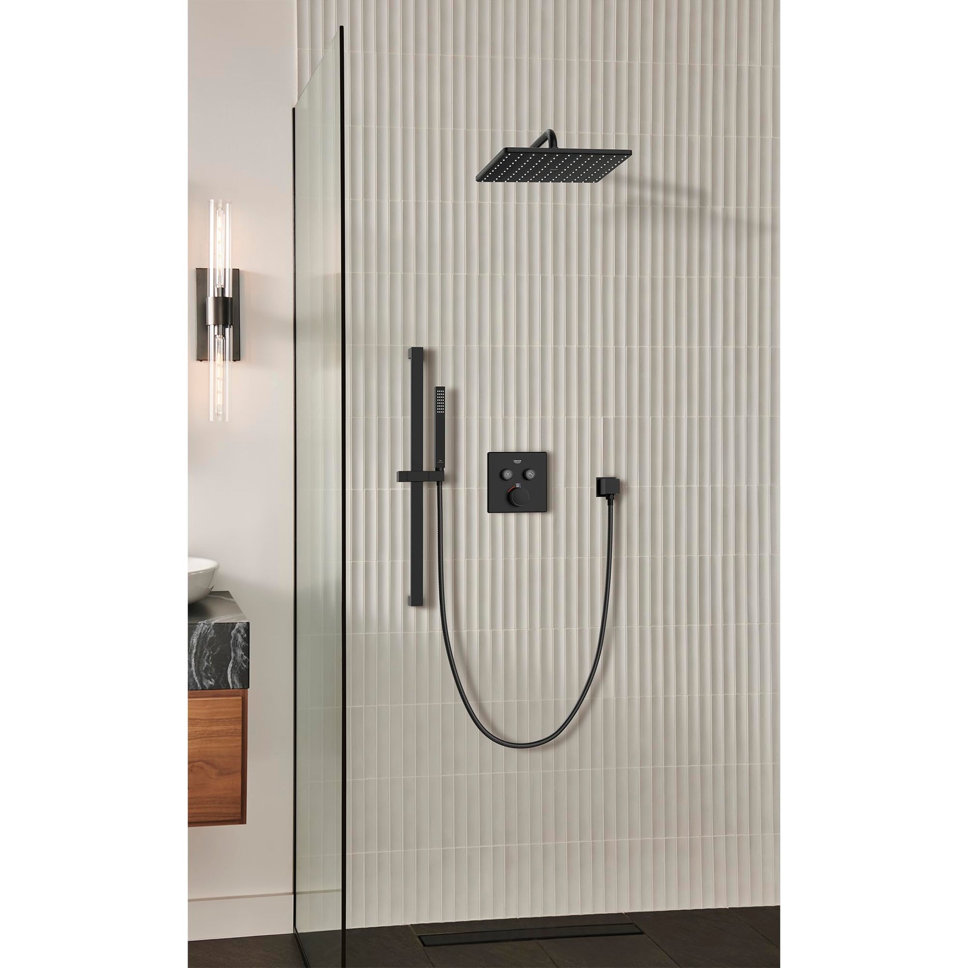 Matte black hand shower system with overhead shower head, wall-mounted control valve, and handheld shower on hose installed i