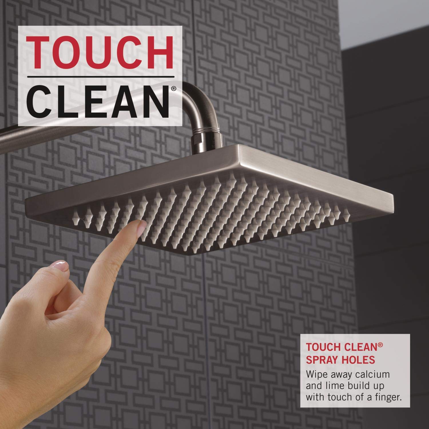Stainless steel square raincan shower head with multiple spray holes mounted on wall, hand pointing at nozzles.
